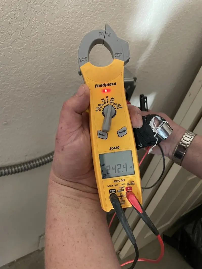 Voltage testing with clamp meter during Electrical Installation Services in Rogers